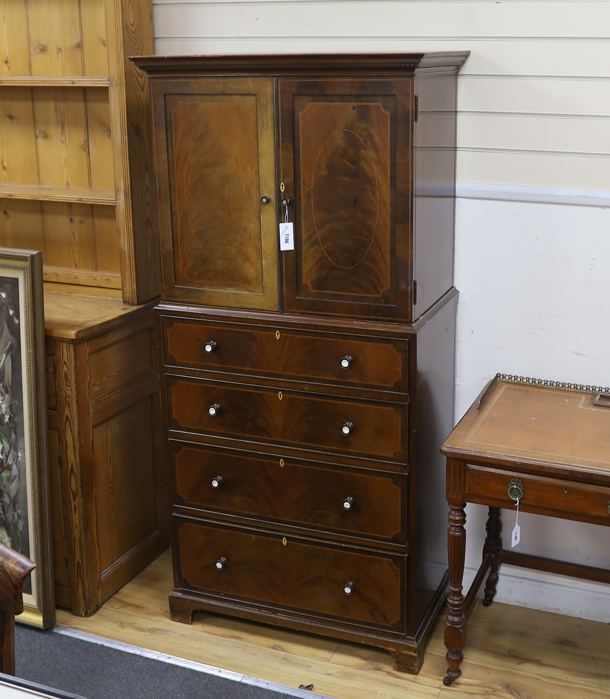 An early 20th century Maple & Co. mahogany narrow press cupboard, width 80cm, depth 45cm, height 168cm